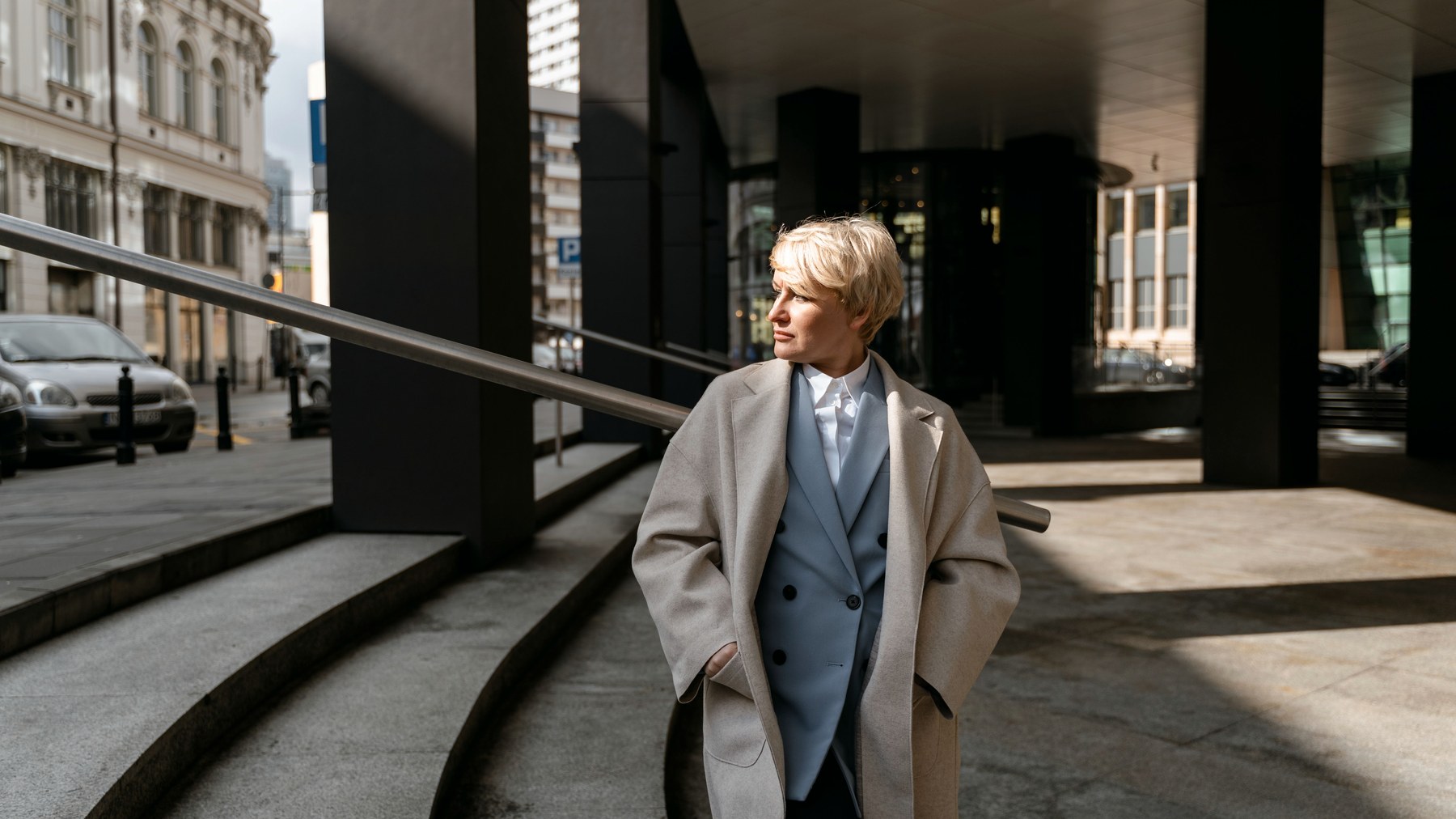 Quiet luxury Switzerland outfit with beige coat and no visible logos in an urban setting