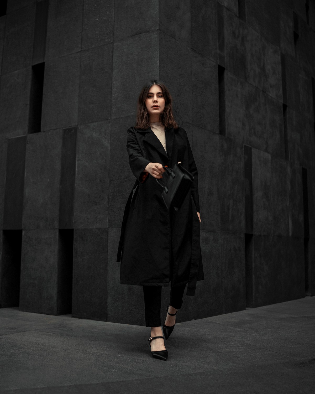 No logo quiet luxury outfit with black coat and minimalist handbag