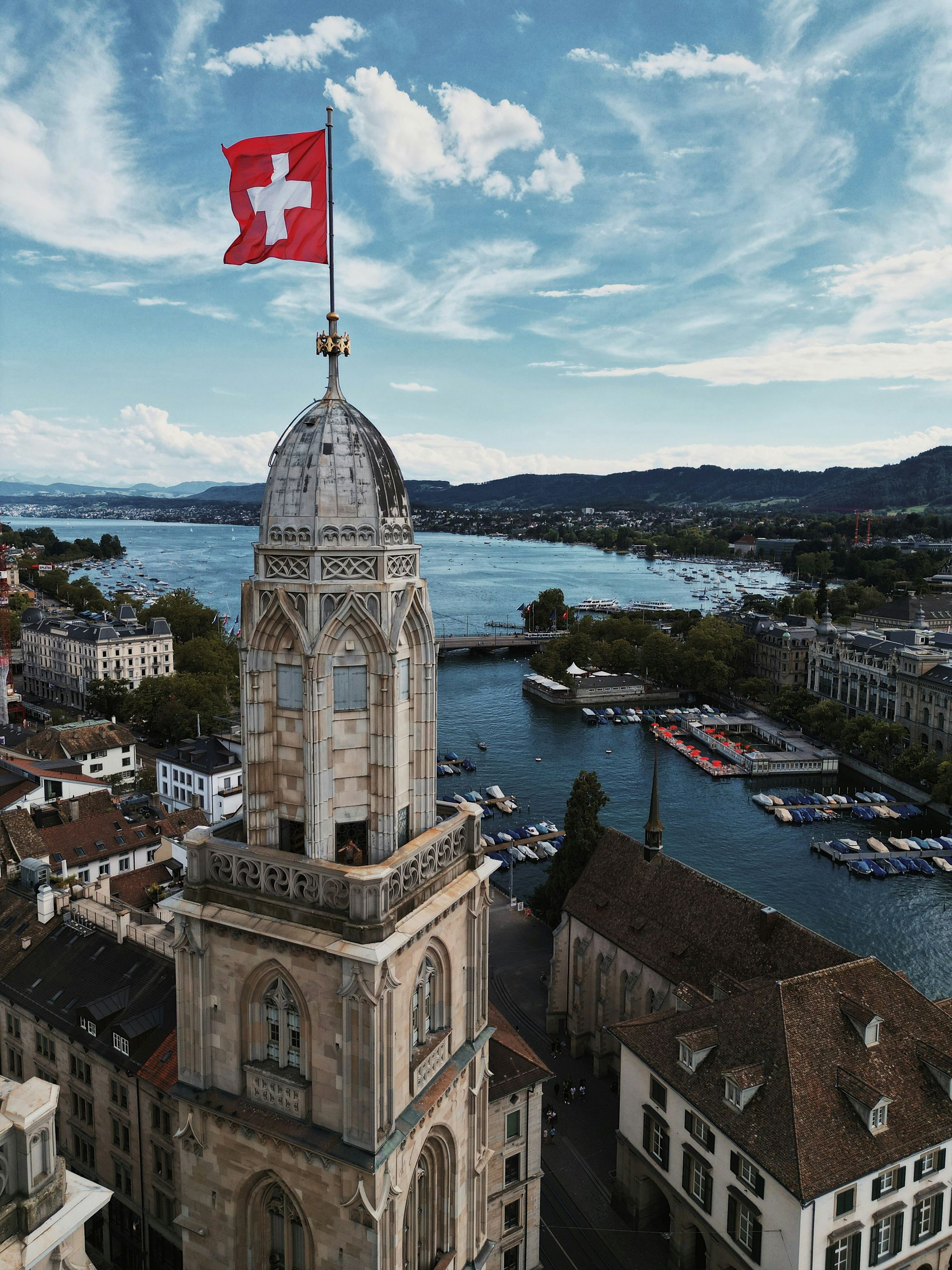 Stunning aerial view of Zurich's architecture with Swiss flag atop a church tower.