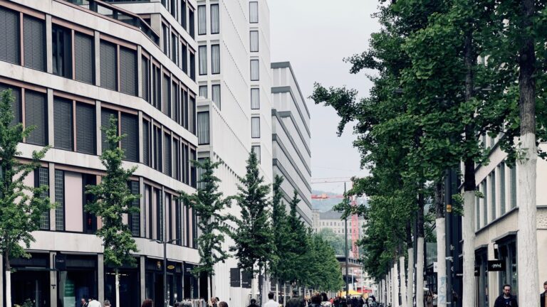Zurich street style in a modern city district with pedestrians, bicycles and contemporary storefronts