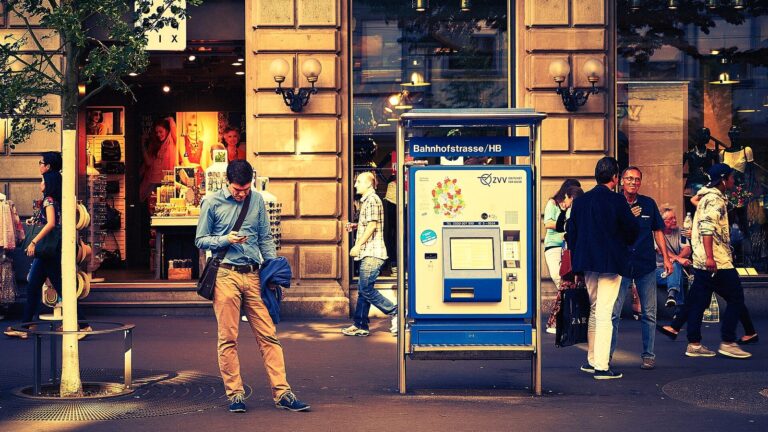 Bahnhofstrasse street style census scene with pedestrians and trams at a Zurich tram stop