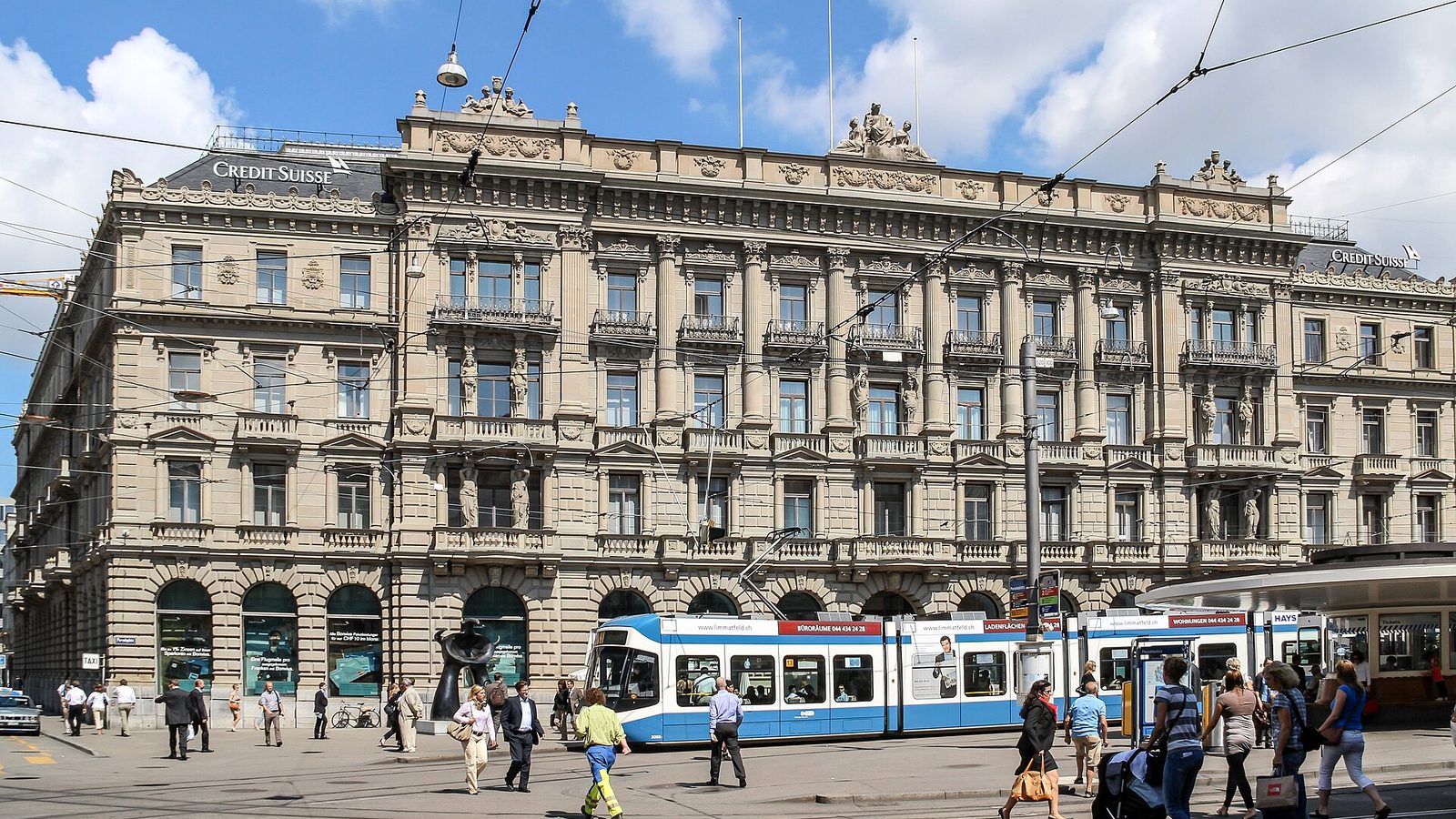 Paradeplatz square in Zurich with trams, banks and pedestrians in business clothing