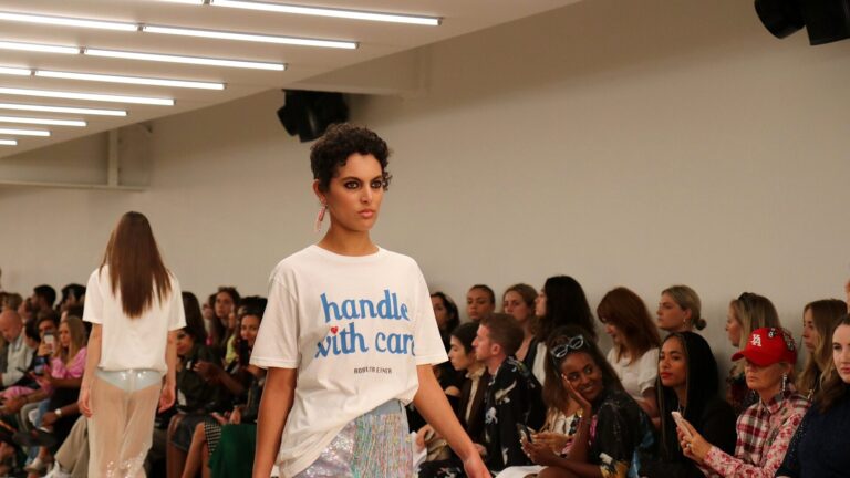 Models on a fashion-week catwalk, evoking Zurich's queer fashion show runway
